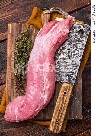 Juicy uncooked pork tenderloin, a versatile choice for any culinary creation you have in mind. wooden background. top view Juicy uncooked pork tenderloin, a versatile choice for any culinary creation you have in mind. wooden background. top view 137438239