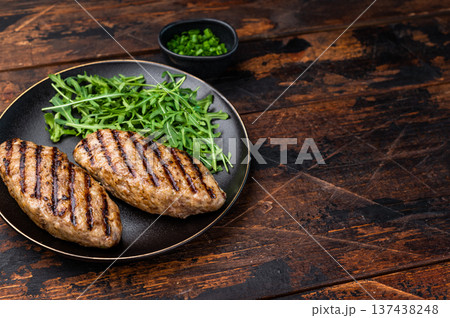 A platter of flavorful bbq roast kofta kebabs, beautifully garnished with vegetables and ready to delight your taste buds. wooden background. top view 137438248