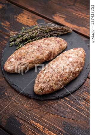 A platter of raw lula kebabs marinated in aromatic herbs, perfect for barbecuing or grilling at your next gathering. wooden background. top view 137438253