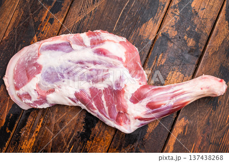 Juicy raw mutton lamb shoulder cut, showcasing its vibrant color and texture, perfect for grilling or braising. wooden background. top view Juicy raw mutton lamb shoulder cut, showcasing its vibrant color and texture, perfect for grilling or braising. wooden background. top view 137438268