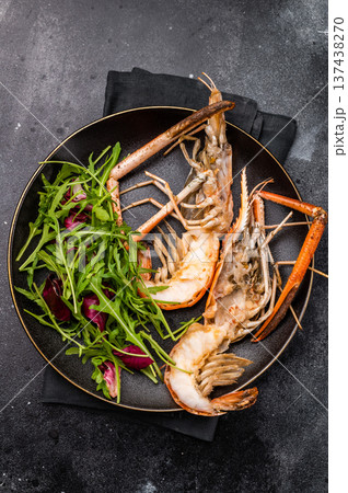 Elegant plate of grilled rosenbergii prawns shrimps garnished with fresh herbs, perfect for gourmet dining experiences. black background. top view Elegant plate of grilled rosenbergii prawns shrimps garnished with fresh herbs, perfect for gourmet dining experiences. black background. top view 137438270