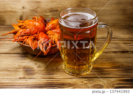 Boiled crayfish and mug of beer on a wooden table Boiled crayfish and mug of beer on a wooden table 137441993