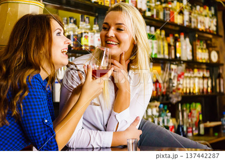Girls in pub club gossiping and talking Girls in pub club gossiping and talking 137442287