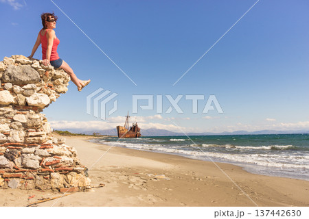 Tourist woman on beach enjoying vacation Tourist woman on beach enjoying vacation 137442630