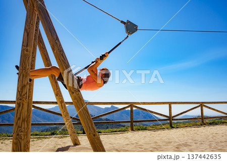 Adult woman having fun on zipline 137442635