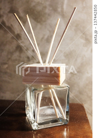 Air refresher or home fragrance Diffuser with reed sticks on wooden table 137442850