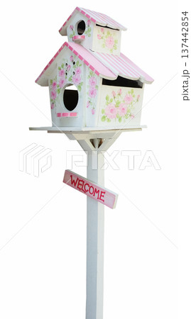 Cute sweet pink and white wooden Birdhouse with with welcome message on wood isolated on white background with clipping path 137442854