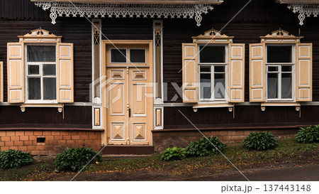 Traditional Wooden House Facade with Ornate Windows and Door Traditional Wooden House Facade with Ornate Windows and Door 137443148