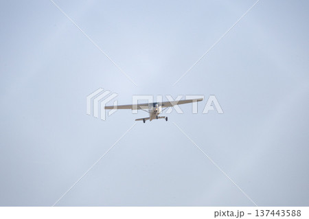 Small airplane flying in clear blue sky Small airplane flying in clear blue sky 137443588