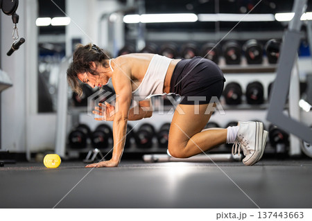 Woman exercising in gym doing functional training workout Woman exercising in gym doing functional training workout 137443663