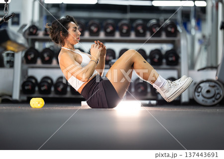 Woman exercising abdominals in gym training for fitness 137443691