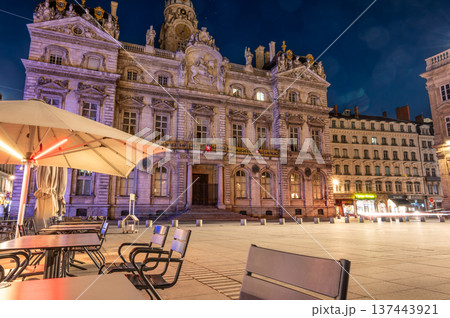 Lyon, france. December 27, 2023. Lyon city hall illuminated at night, seen from an outdoor cafe terrace in place des terreaux, highlighting european city life Lyon, france. December 27, 2023. Lyon city hall illuminated at night, seen from an outdoor cafe terrace in place des terreaux, highlighting european city life 137443921