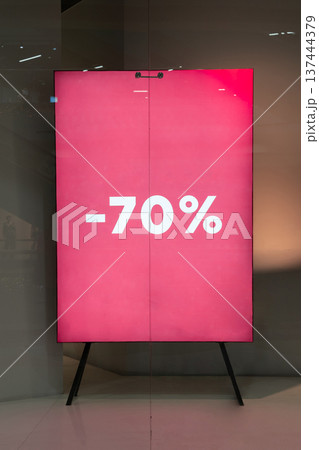Bold red sale sign with 70 percent discount displayed at storefront Bold red sale sign with 70 percent discount displayed at storefront 137444379
