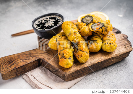Gimmari, korean deep fried snack, seawed rolls and noodles glass. grey background. top view Gimmari, korean deep fried snack, seawed rolls and noodles glass. grey background. top view 137444408