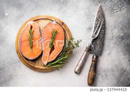 Premium salmon loin steak, expertly cut and displayed, perfect for culinary creations. Elevate your dishes with this delicious seafood option. grey background. top view Premium salmon loin steak, expertly cut and displayed, perfect for culinary creations. Elevate your dishes with this delicious seafood option. grey background. top view 137444428