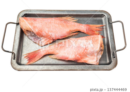 Raw redfish halves on metal tray with lemon and thyme. Fresh seafood ingredient on isolated background with copy space. Raw redfish halves on metal tray with lemon and thyme. Fresh seafood ingredient on isolated background with copy space. 137444469
