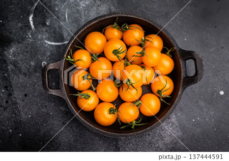 Fresh small yellow tomatoes, cherry tomatoes assortment, cocktail mix. black background. top view 137444591