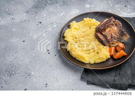 Slow cooked Beef short ribs, perfectly cooked and glazed with a rich barbecue sauce. grey background. top view Slow cooked Beef short ribs, perfectly cooked and glazed with a rich barbecue sauce. grey background. top view 137444608