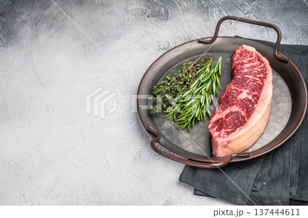 Raw rump cap steak, beef meat, showcasing its rich color and marbling. grey background. top view 137444611