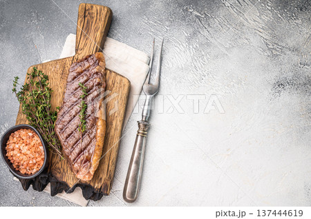 Grilled Top Sirloin, cooked rump beef steak. grey background. top view Grilled Top Sirloin, cooked rump beef steak. grey background. top view 137444619