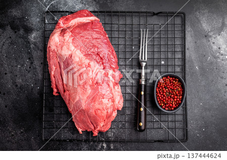 Close-up of raw boneless beef shank cuts, highlighting their tender texture and vibrant hue, ideal for culinary enthusiasts seeking quality ingredients. black background. top view Close-up of raw boneless beef shank cuts, highlighting their tender texture and vibrant hue, ideal for culinary enthusiasts seeking quality ingredients. black background. top view 137444624