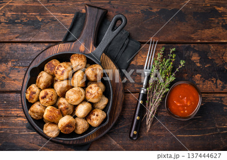 Delicious meatballs, meat patties, showcasing a golden crust and tender interior. isolated on wooden background. top view Delicious meatballs, meat patties, showcasing a golden crust and tender interior. isolated on wooden background. top view 137444627