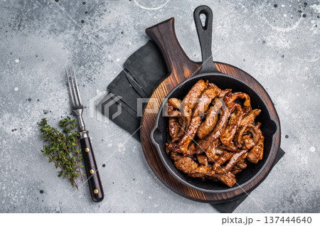 Delicious glazed teriyaki beef in a skillet. grey background. top view 137444640