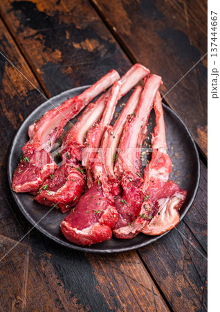 Raw lamb chop cutlets, fresh mutton meat for steaks with herbs. wooden background. top view 137444667