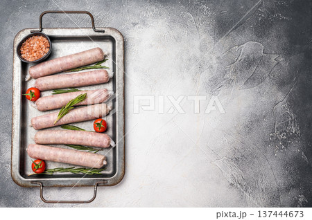 Fresh Sausages with minced pork and veal meat, wurst with herbs. grey background. top view Fresh Sausages with minced pork and veal meat, wurst with herbs. grey background. top view 137444673