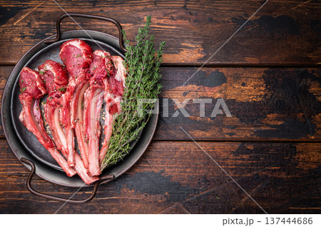 Raw lamb chop cutlets, fresh mutton meat for steaks with herbs. wooden background. top view Raw lamb chop cutlets, fresh mutton meat for steaks with herbs. wooden background. top view 137444686