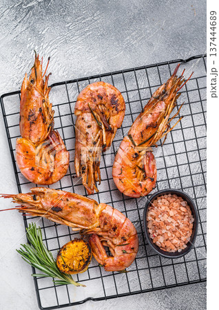 Seafood BBQ with Grilled red Argentine shrimps, Prawns Langostino Austral on a rack with herbs. grey background. top view 137444689