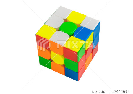 Bright speedcube puzzle toy photographed in clean studio light, geometric colorful blocks symbolizing intelligence, strategy and problem solving skills. 137444699