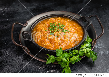 Roasted eggplant aubergine kyopolou vegetable dip served in iron skillet with parsley garnish on dark textured background top view with copy space Roasted eggplant aubergine kyopolou vegetable dip served in iron skillet with parsley garnish on dark textured background top view with copy space 137444748