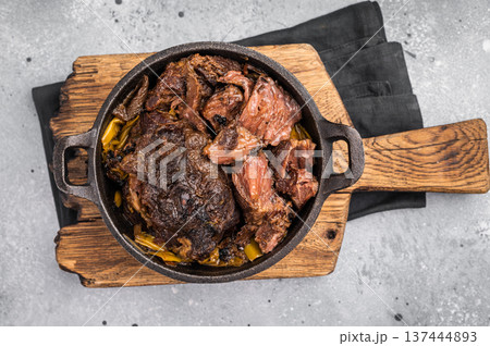Red Wine Braised Beef Cheek meat with Creamy sauce in a skillet. grey background. top view 137444893