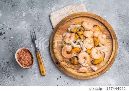 Frozen Raw Seafood Cocktail with Mussels, Clams, Prawns, Shrimps and squid. grey background. top view Frozen Raw Seafood Cocktail with Mussels, Clams, Prawns, Shrimps and squid. grey background. top view 137444922