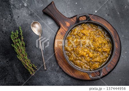 Traditional pickle relish with rich texture served in cast iron skillet on dark stone surface gourmet food background Traditional pickle relish with rich texture served in cast iron skillet on dark stone surface gourmet food background 137444956
