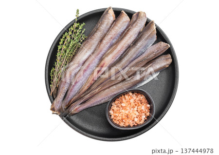 Uncooked blue whiting seafood arranged on isolated background, silver ocean fish similar to hake and codling, clean culinary composition with herbs and seasoning 137444978