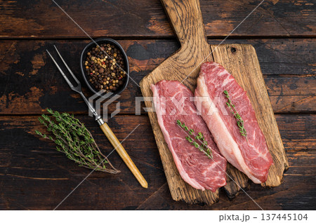 Uncooked picanha also called culotte or top sirloin cap, marbled beef steak with fat cap, rustic presentation on wooden board Uncooked picanha also called culotte or top sirloin cap, marbled beef steak with fat cap, rustic presentation on wooden board 137445104