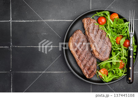 Juicy grilled beef culotte steak with arugula salad, sirloin cap cut served for healthy lunch or dinner 137445108