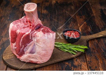 Uncooked beef shank knuckle joint with bone on rustic cutting board ingredient for braising and ossobuco Uncooked beef shank knuckle joint with bone on rustic cutting board ingredient for braising and ossobuco 137445110