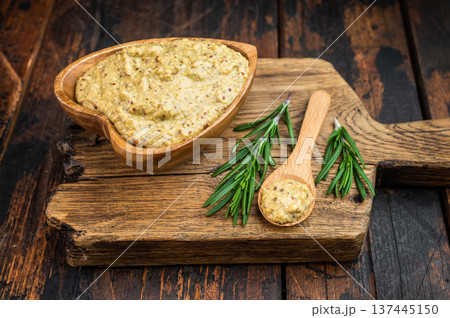 Bavarian sweet mustard with mild grainy texture in wooden bowl with spoon and rosemary flat lay on rustic wood background Bavarian sweet mustard with mild grainy texture in wooden bowl with spoon and rosemary flat lay on rustic wood background 137445150