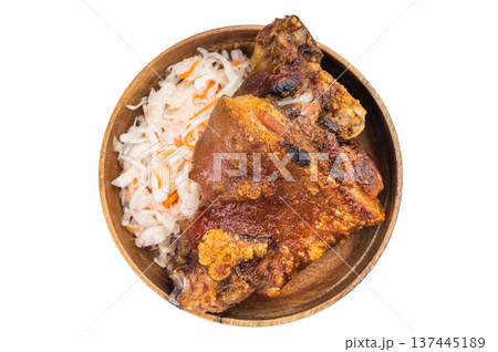 Crispy roasted pork knuckle with deep maillard browning served over fermented cabbage slaw in a wooden bowl on clean white background. Crispy roasted pork knuckle with deep maillard browning served over fermented cabbage slaw in a wooden bowl on clean white background. 137445189