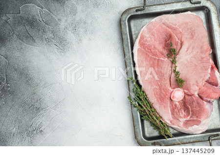 Uncooked pork shoulder whole piece with bone on tray isolated on grey background raw pink meat ingredient for roasting braising stew Uncooked pork shoulder whole piece with bone on tray isolated on grey background raw pink meat ingredient for roasting braising stew 137445209