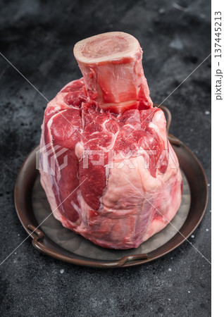 Raw veal shank hock whole piece with bone in cooking pan on stone background premium calf meat for braising and cuisine 137445213