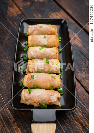 Fried spring rolls Lumpia crunchy appetizer with soy sauce and scallions minimal Asian food concept Fried spring rolls Lumpia crunchy appetizer with soy sauce and scallions minimal Asian food concept 137445236