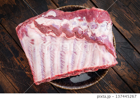 Uncooked pork spareribs slab with marbled meat and rosemary butcher style composition on isolated white background Uncooked pork spareribs slab with marbled meat and rosemary butcher style composition on isolated white background 137445267