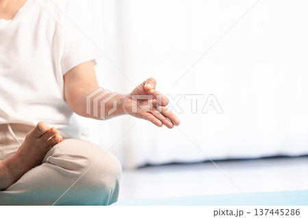 Close-up of hands in yoga meditation mudra during mindfulness practice, soft bright background with copy space. Calm wellness concept for relaxation, breathing, zen and mental health. Close-up of hands in yoga meditation mudra during mindfulness practice, soft bright background with copy space. Calm wellness concept for relaxation, breathing, zen and mental health. 137445286