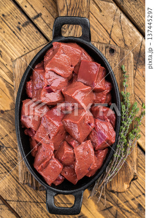 Fresh diced beef calf liver prepared for cooking in skillet on wooden background. Traditional offal ingredient 137445297