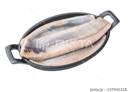 Pickled herring fillets cured in salt and brine arranged in iron pan. Minimal white background traditional seafood ingredient. Pickled herring fillets cured in salt and brine arranged in iron pan. Minimal white background traditional seafood ingredient. 137445328