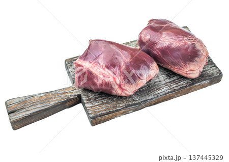 Unprocessed veal heart organs with visible connective tissue collagen bands and smooth muscle structure on wooden board. Unprocessed veal heart organs with visible connective tissue collagen bands and smooth muscle structure on wooden board. 137445329